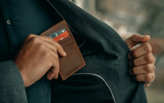 a man holding a wallet in his pocket