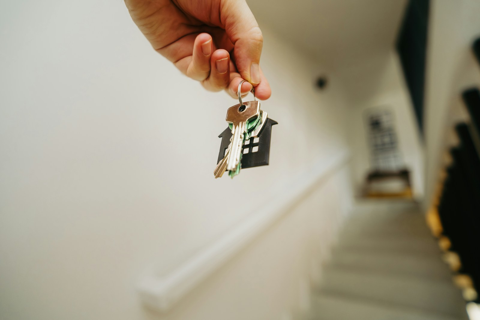 A person holding a house key in their hand